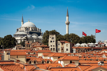 Fatih, Istanbul, Turkey - June 13, 2024: View of the rooftops of the Grand Bazaar with mosque in the background. Historical buildings of istanbul. Selective focus. 