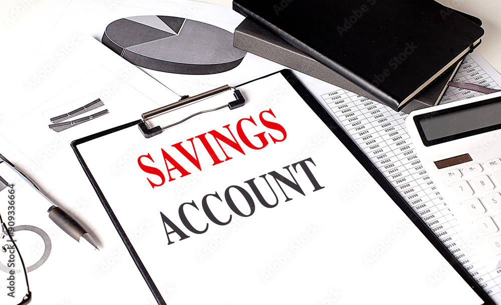 Poster savings accont text on clipboard on chart with notebook and calculator