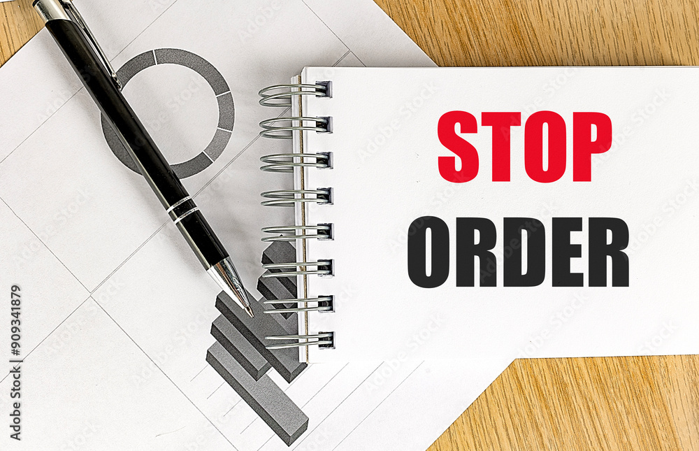 Poster STOP ORDER text on notebook with chart on wooden background