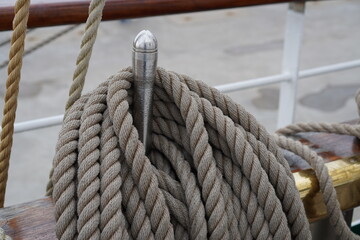 Close up of many ropes coiled up on board of a sailing tall ship