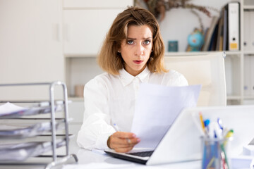 Tired businesswoman working with documents in office at the table