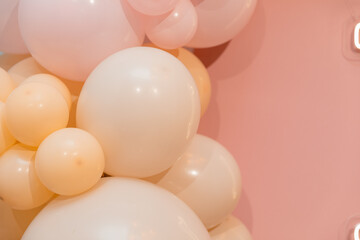 Background of balloons in various sizes and colors, including coral, pink, and beige. Сopy space.