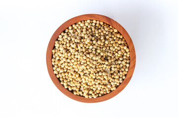 White pepper seeds or Peppercorns in a wooden bowl isolated on white background. Top view. Flat lay
