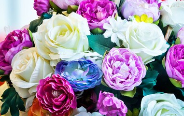 A bouquet of flowers with a variety of colors including white, pink, and purple. The flowers are arranged in a vase and are in full bloom. Concept of beauty and freshness © SAKCHAI