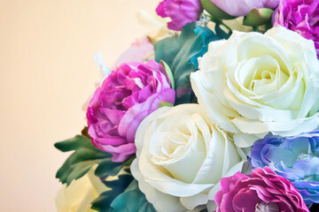 A bouquet of flowers with a mix of white and purple flowers. The flowers are arranged in a vase and are placed on a table. Scene is cheerful and bright, as the flowers are colorful and vibrant