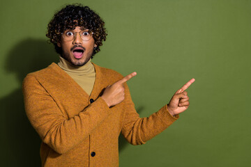 Photo portrait of pretty young male point shocked empty space wear trendy brown outfit isolated on khaki color background