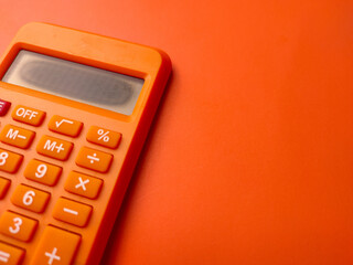 Closeup orange calculator on a orange background