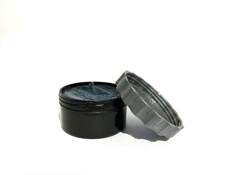 A jar of transparent hair styling pomade cream gel isolated on white background