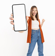 Studio shot of Beautiful Asian woman holding smartphone mockup of blank screen and smiling isolated...