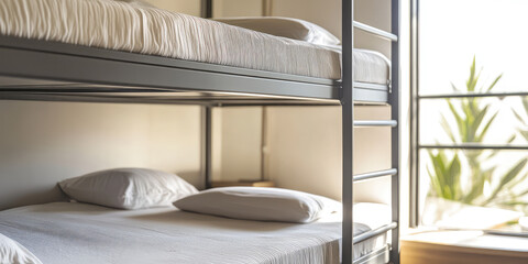 Simple empty bunk beds in sunny room. Shared bunk bed dormitory room, hostel accommodation interior. 