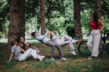 Friends relaxing and enjoying their time in a park with a hammock and bicycles