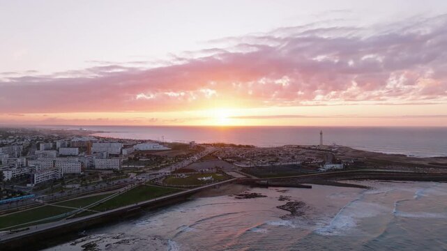 Stunning 4K Aerial Footage of Casablanca Lighthouse and Cityscape at Sunset - Scenic Panoramic View of Morocco's Coastal Landmark with Vibrant Colors and Golden Hour Glow