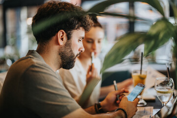 Businesspeople meeting at a coffee bar, engaging in discussions using mobile phones and notes, creating a collaborative environment.