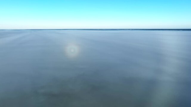 Rare weather phenomenon ringed glory and part of white rainbow on the surface of the fog. Saaremaa, Estonia.