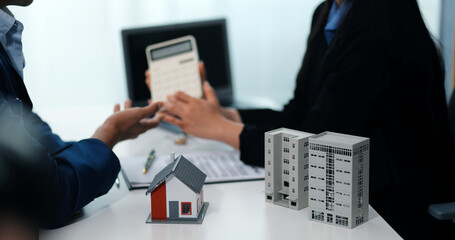 Sale representative offer house purchase contract to buy a house or apartment or discussing about loans and interest rates