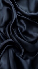 Fototapeta premium Dark blue silk fabric with flowing folds, abstract background. Luxury and elegance concept