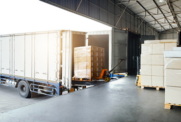Bulk pallets of packaging boxes being loaded onto a container truck. distribution warehouse...
