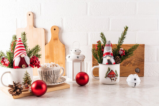 A cup of hot cocoa with marshmallows on the kitchen countertop among Christmas decorations for the New Year and Christmas holidays