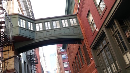 New York City Staple street skybridge. Vintage retro industrial architecture, red brick building. American old historic cooper elevated sky bridge Manhattan landmark, USA. Fire escape ladder.