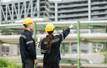 Both of Petroleum engineer is on a mission to inspect oil distillation at a huge oil refinery - Powered by Adobe