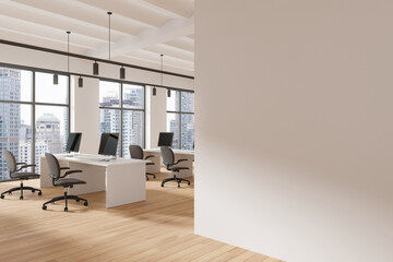 Coworking interior with desks and pc computers near window. Mockup wall