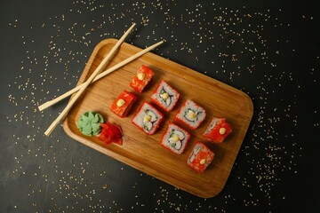 Sushi Rolls on Wooden Board