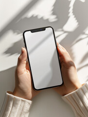 A versatile mockup featuring a hand holding a smartphone with a blank screen. Perfect for showcasing mobile app designs,