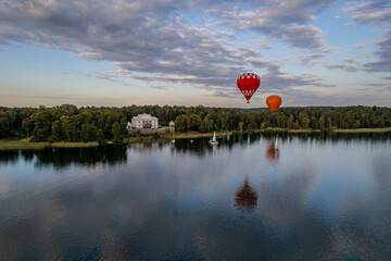 Aerial summer sunny view of hot air balloon over Galve lake in Trakai, Uzutrakis, Lithuania