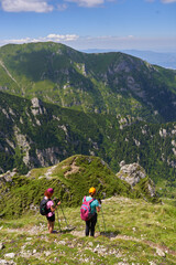 Hiker women with backpacks on a trail