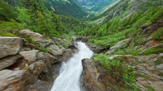 A stunning aerial view of Cascate del Rutor waterfall surrounded by lush green forest