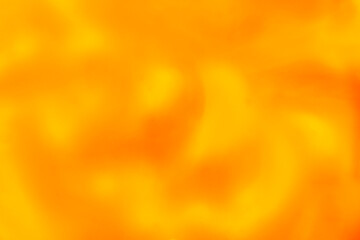 close up of liquid orange and yellow paints background