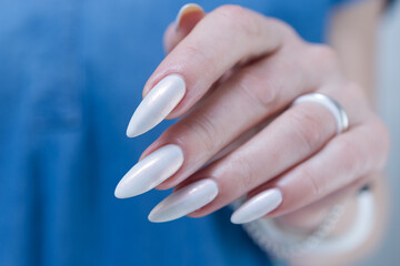 beautiful female hands with long nails light white manicure