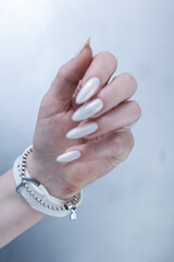 beautiful female hands with long nails light white manicure