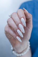 beautiful female hands with long nails light white manicure