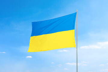 Ukrainian flag flying proudly, symbolizing faith and national pride. The flag's vibrant colors and fluttering motion emphasize the spirit and resilience of Ukraine