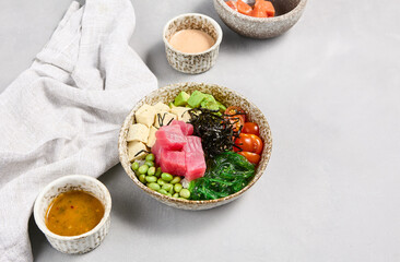 Tuna Poke Bowl with Edamame, Avocado, and Cherry Tomatoes on a Light Gray Background