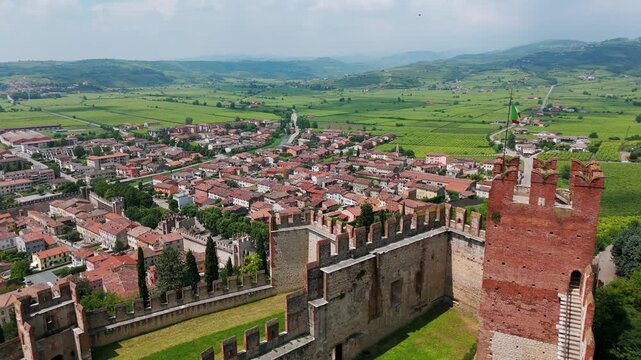 Aerial view of Soave Castle, showcasing the historic architecture and beautiful surrounding landscapes in Italy. push forward shot