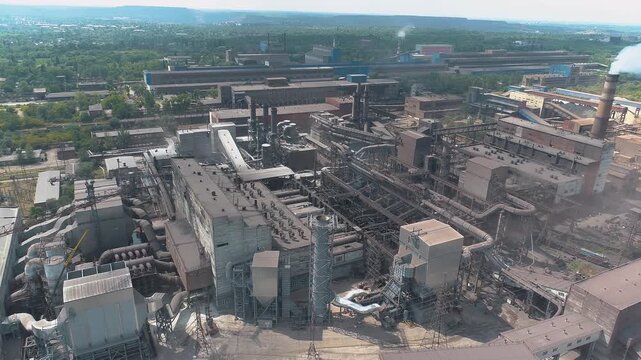Thick white smoke from the chimney of the plant. Emissions from a large plant. Flying near the smoking chimney of the factory
