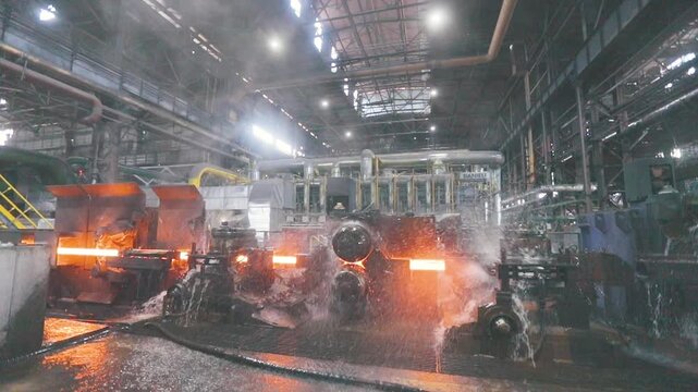 Metal production process in a metallurgical factory. Red hot metal in a modern factory. Modern metallurgical factory