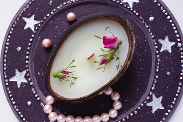 original christmas candle in coconut and fir branches	