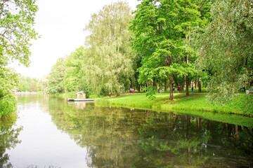 Fototapeta premium A park with a lake and a boat