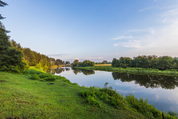 Obraz premium A calm river with trees on both sides