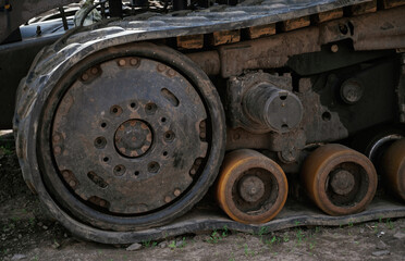 Close-up of old rusty tank tracks with dirt and grime