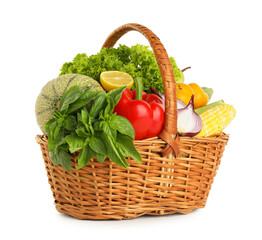 Different fresh fruits and vegetables in wicker basket isolated on white