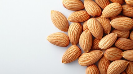 Fototapeta premium Almonds arranged in a pile on a white background, top view 