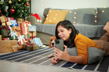 Young woman plays with her favorite dog during a celebration at her home.