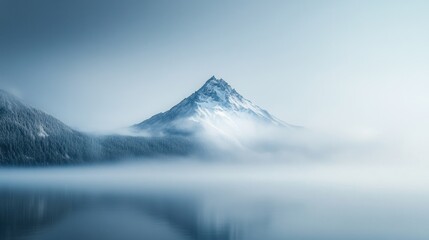 Fototapeta premium Snowy Mountain Peak Emerging from Mist