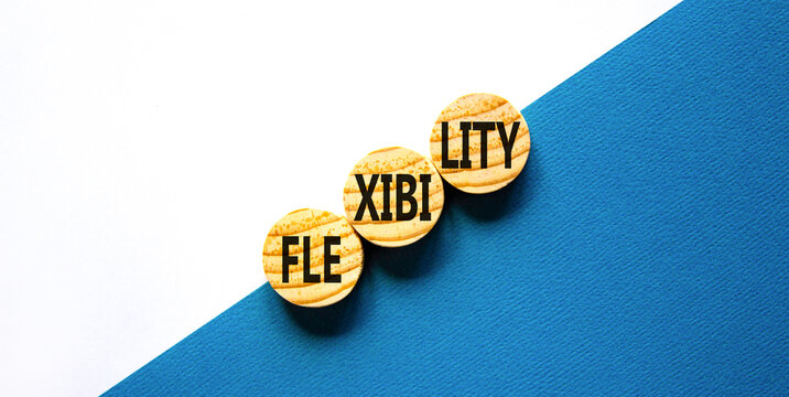 Flexibility symbol. Concept word Flexibility on beautiful wooden circles. Beautiful blue white background. Business flexibility concept. Copy space.