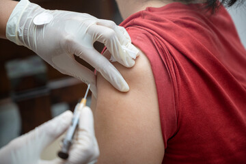A woman is getting a shot in her arm