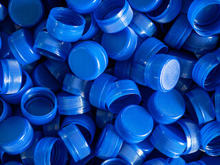 Top view blue plastic bottle caps.Recycling collection and production processing plastic bottle...